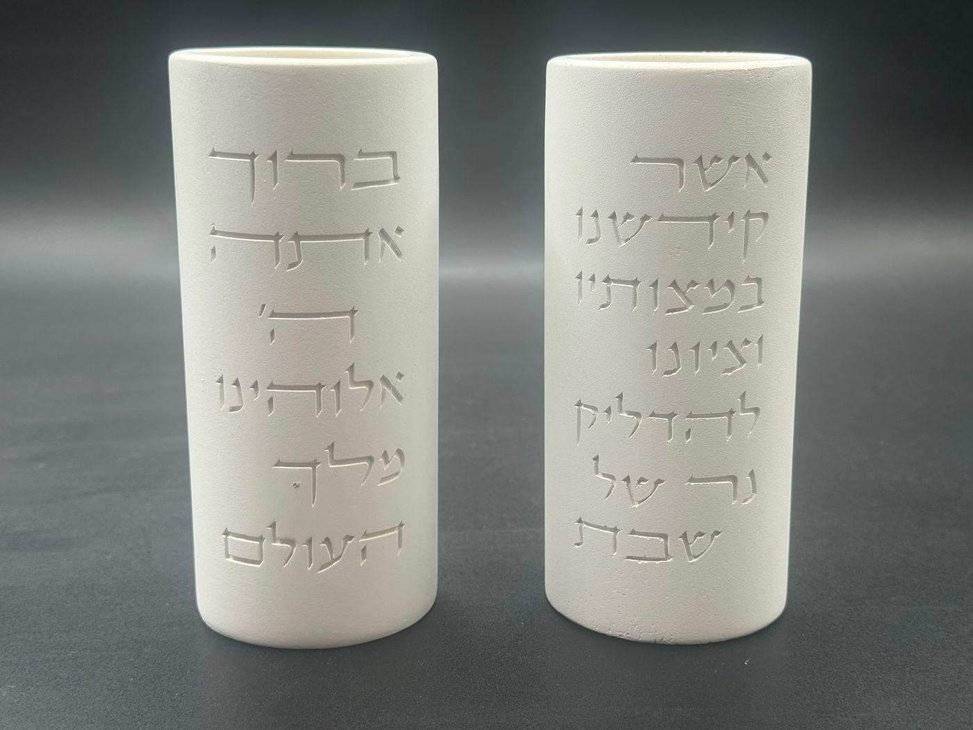 זוג פמוטים לבנים לשבת מבית הדריה עם ברכת הדלקת נרות בכיתוב לבן